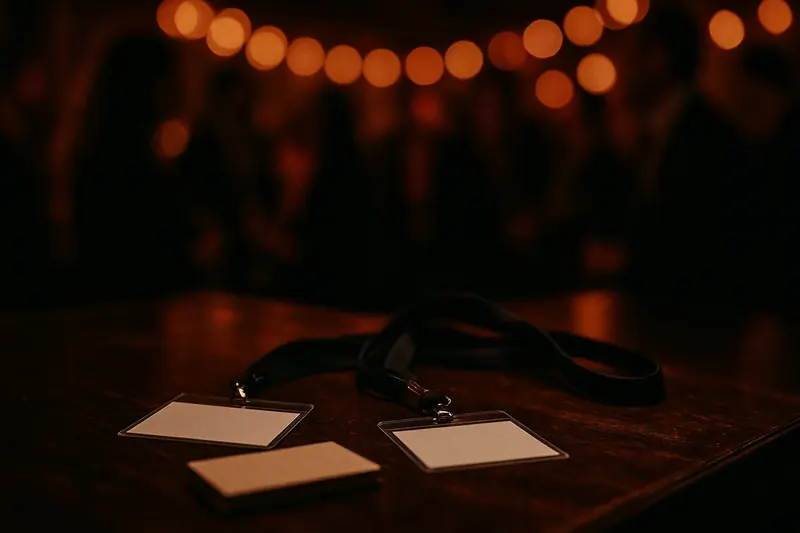 Name badges and business cards on a bar table at an evening networking mixer